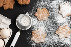 Star-shaped gingerbread cookies, sprinkled powdered sugar, metal, a Food & Drink Photo by ndanko