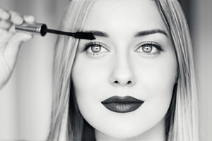 Beautiful blonde woman applying mascara, with dark lipstick, bri, a Person Photo by Studio ANNA