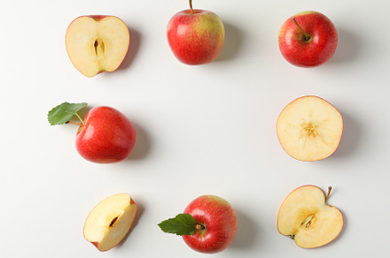 Flat lay with red apples on white background, space for text, a Food & Drink Photo by AtlasStudio