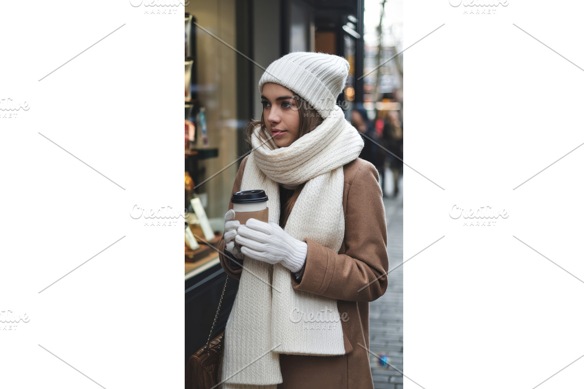 Young woman in winter attire holding, an Illustration by tilialucida