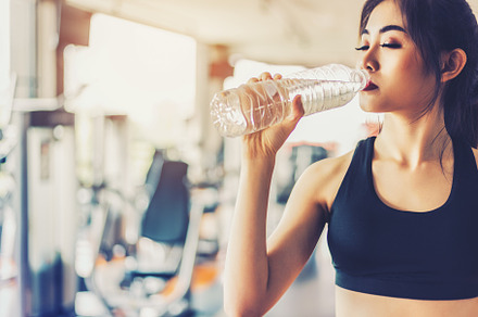 Asian woman drinking pure drinking water for freshness after wor, a Person Photo by Ministocker