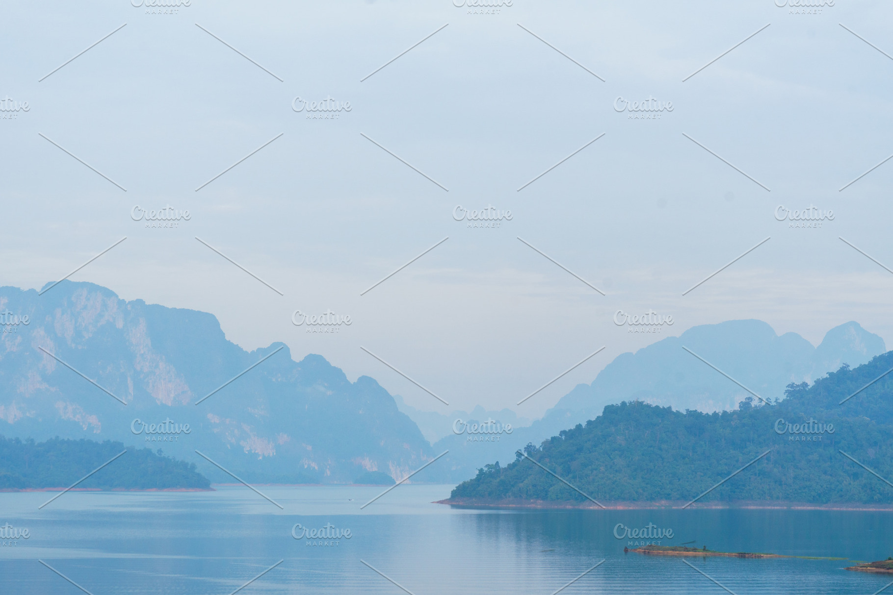 Serene landscape with misty mountains and calm water reflections, a Nature Photo by a454