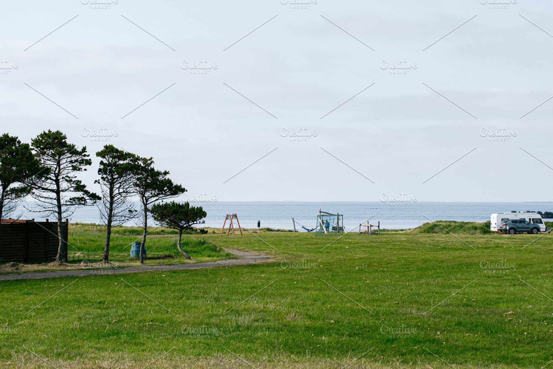 A scenic landscape with trees near a calm Icelandic seaside location, a Photo by AS photostudio