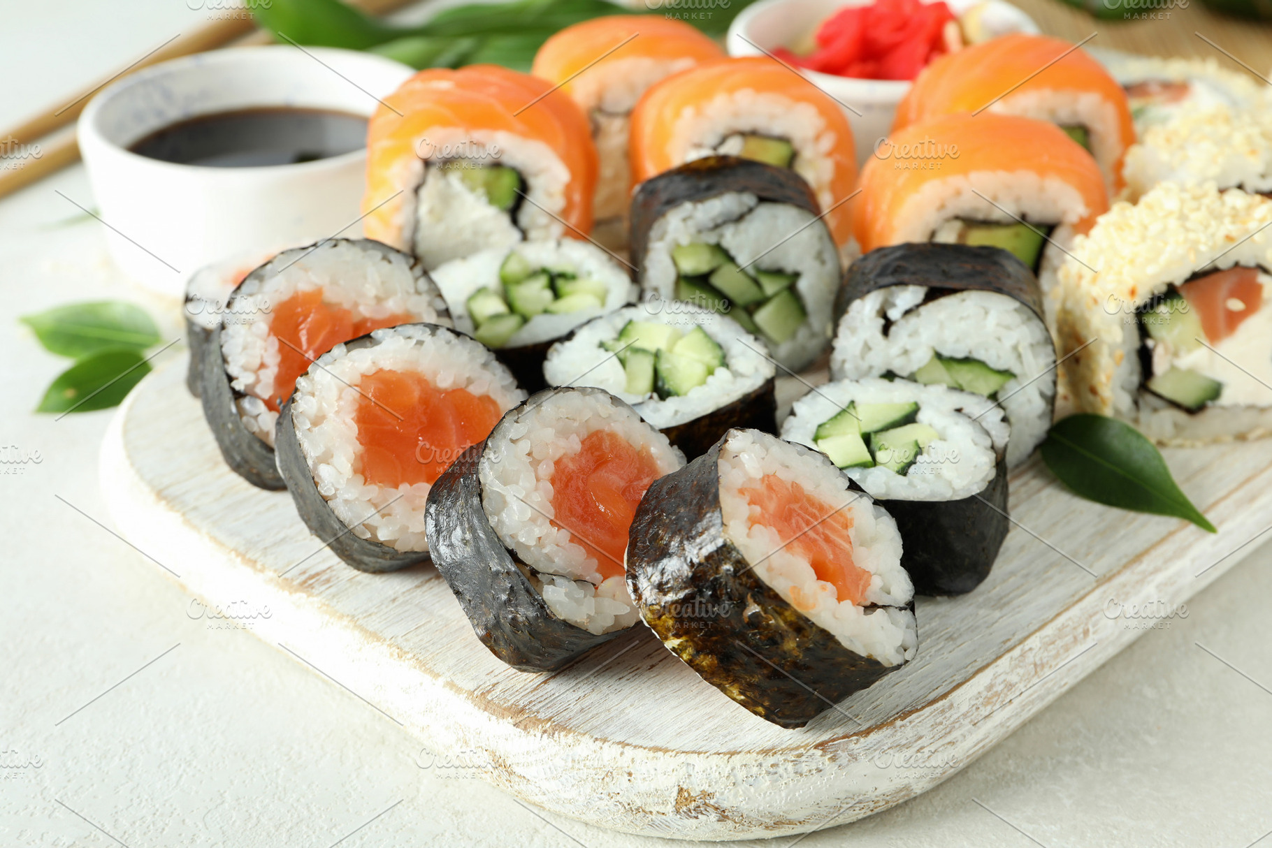 Concept of tasty food with sushi rolls on white textured backgro, a Food & Drink Photo by AtlasStudio PRO