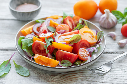 Green salad from leaves and tomatoes, a Food & Drink Photo by Olena Rudo