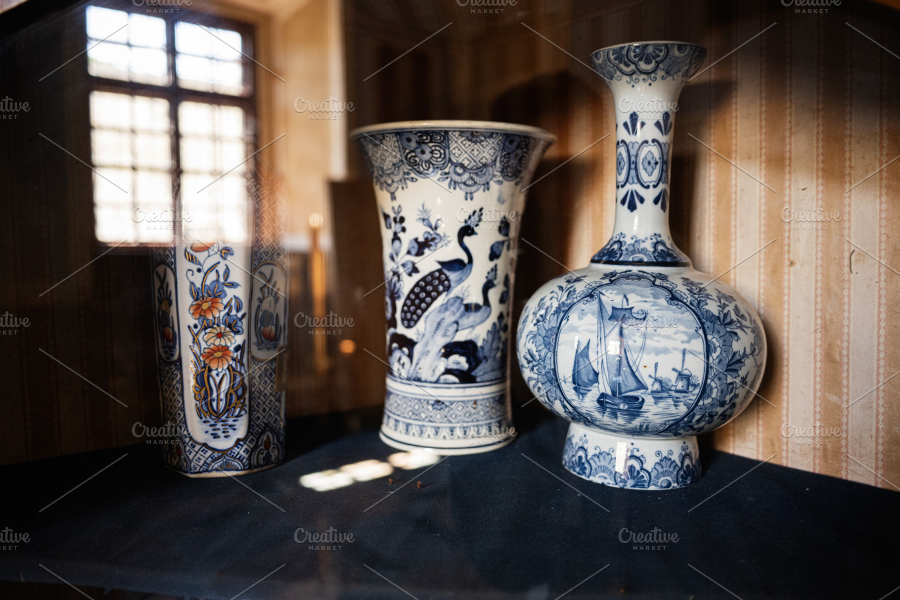 Elegant vintage ceramic vases with intricate blue and white decorative patterns, a Photo by AS photostudio