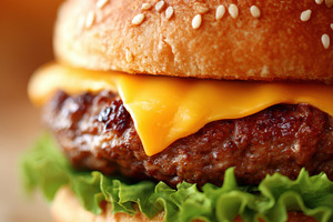 Delicious cheeseburger with melted cheese and fresh toppings, a Food & Drink Photo by AlyaAnd