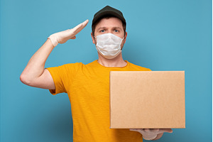 Young delivery man in medical mask