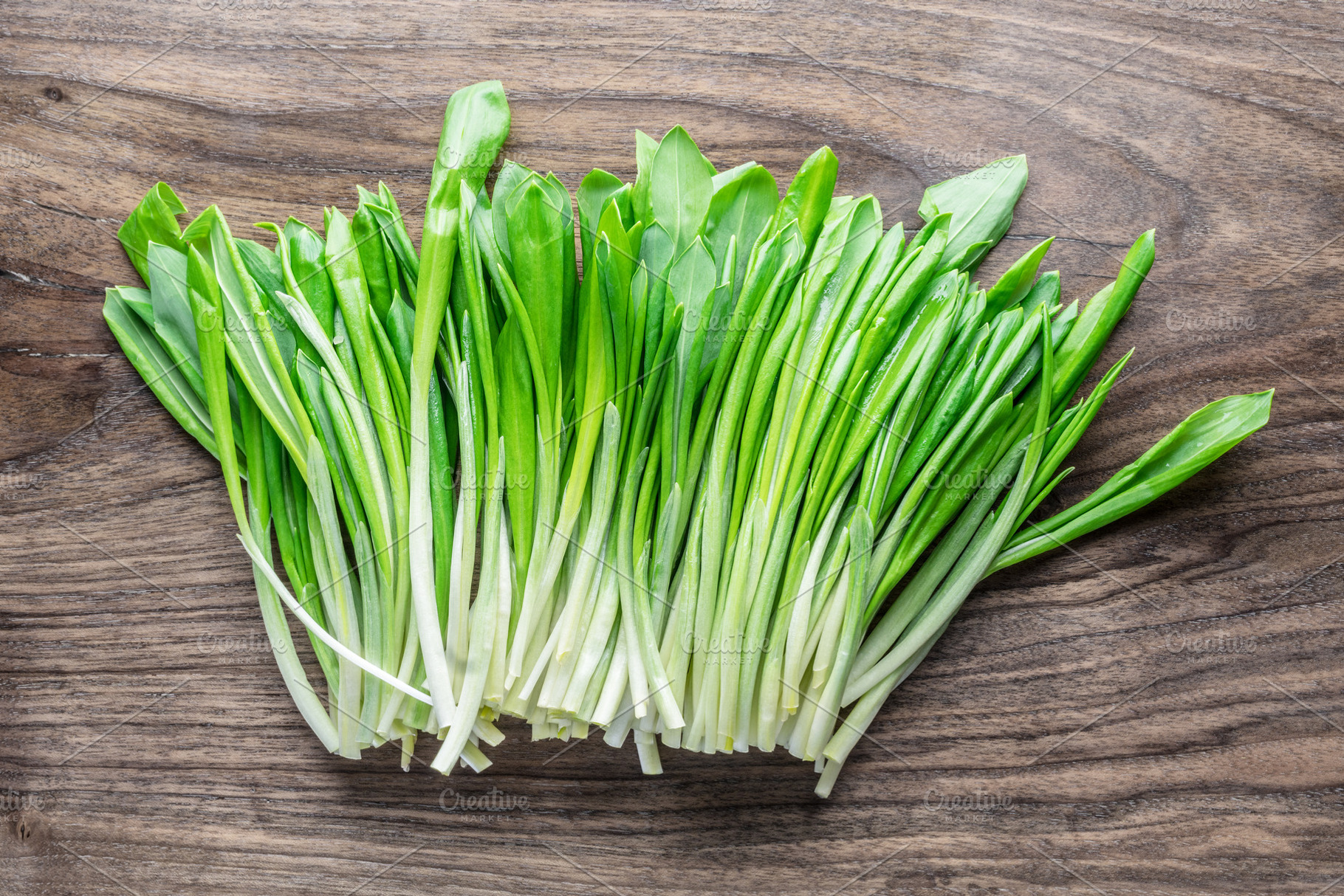Young fresh wild garlic on the wooden table., a Food & Drink Photo by Volff