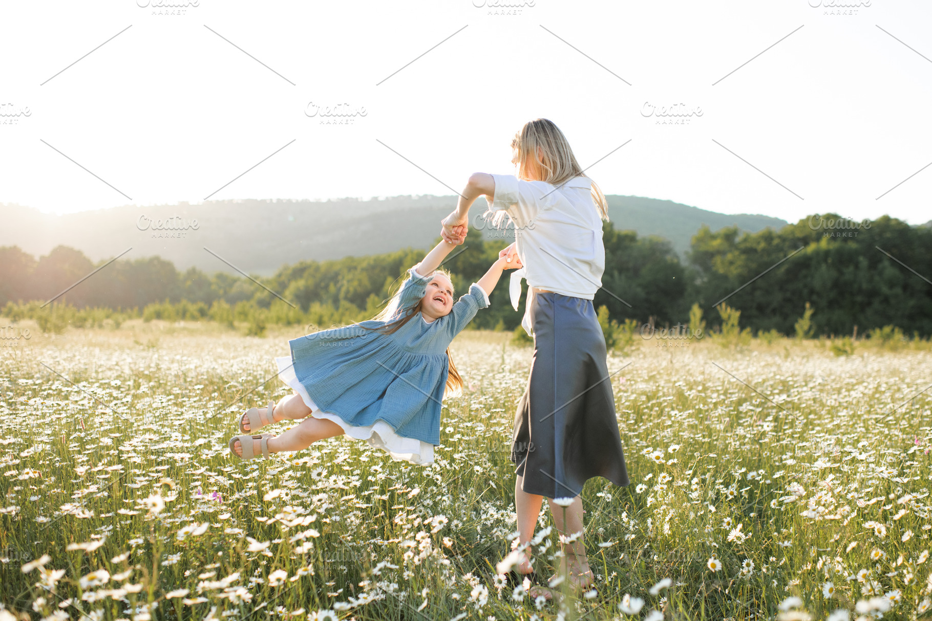 Mother with child girl in flowers, a Person Photo by morrowlight