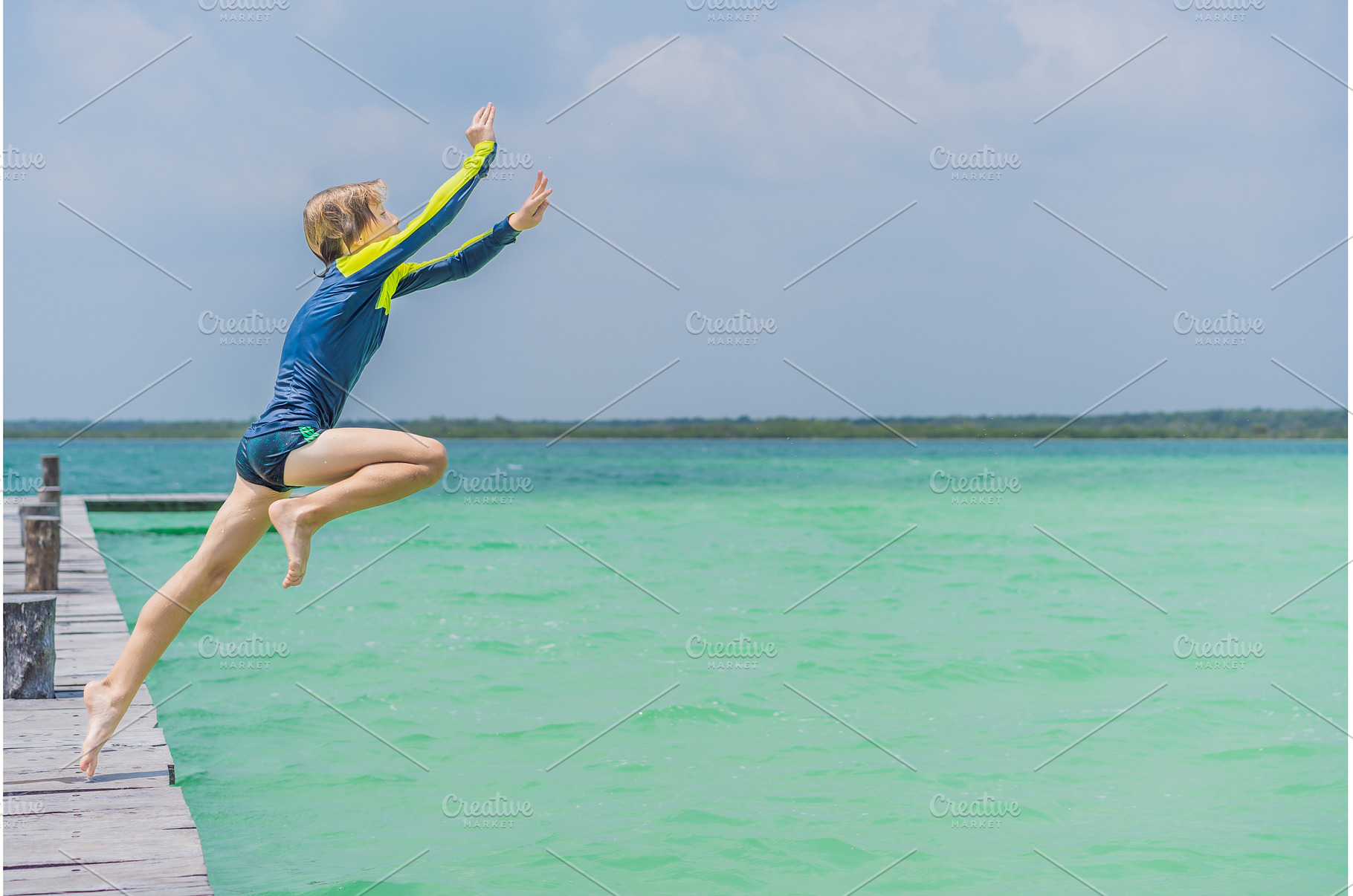 Boy jumping off a pier into a, a Nature Photo by Elizaveta Galitskaya