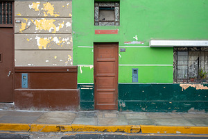 Green wall with windows and door in Lima, Peru, an Architecture Photo by GoodGoods