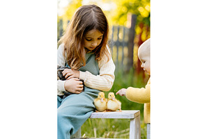 Kids enjoying time with baby animals, a Nature Photo by HalfPoint
