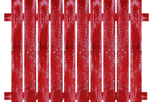 Section of wooden picket fence painted red, isolated background, an Abstract Photo by ndanko