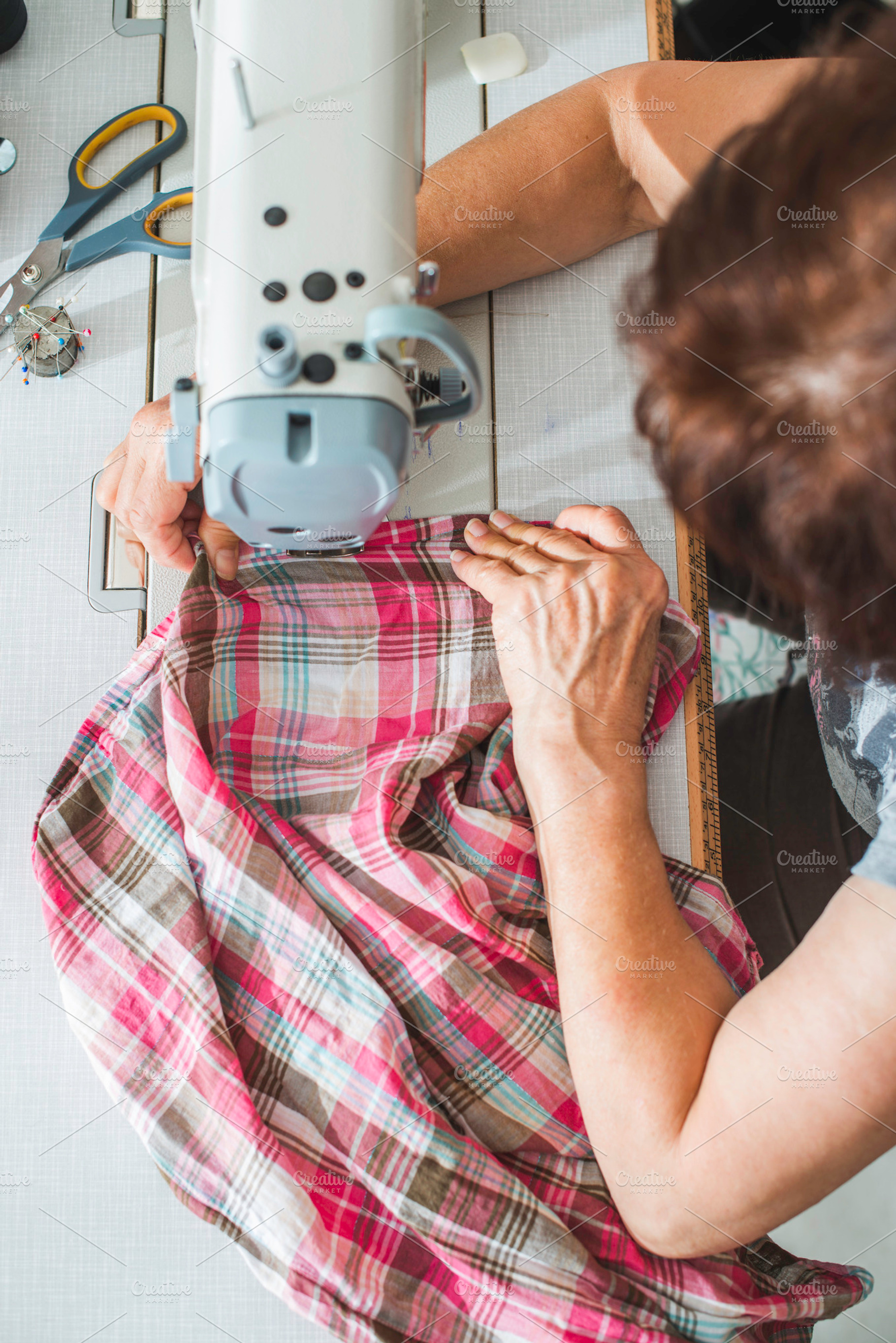 Women sew on sewing machine containing sewing, machine, and woman, an Industrial Photo by Deyan Georgiev