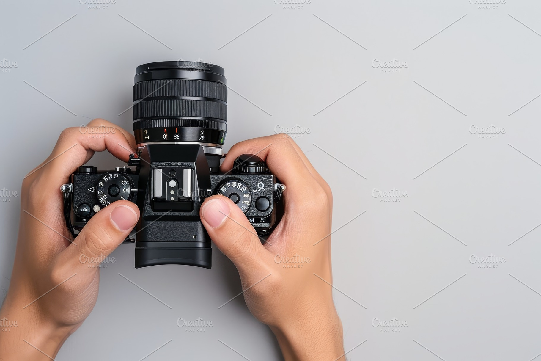 Two hands grip a DSLR camera equippe, a Photo by Tanuart