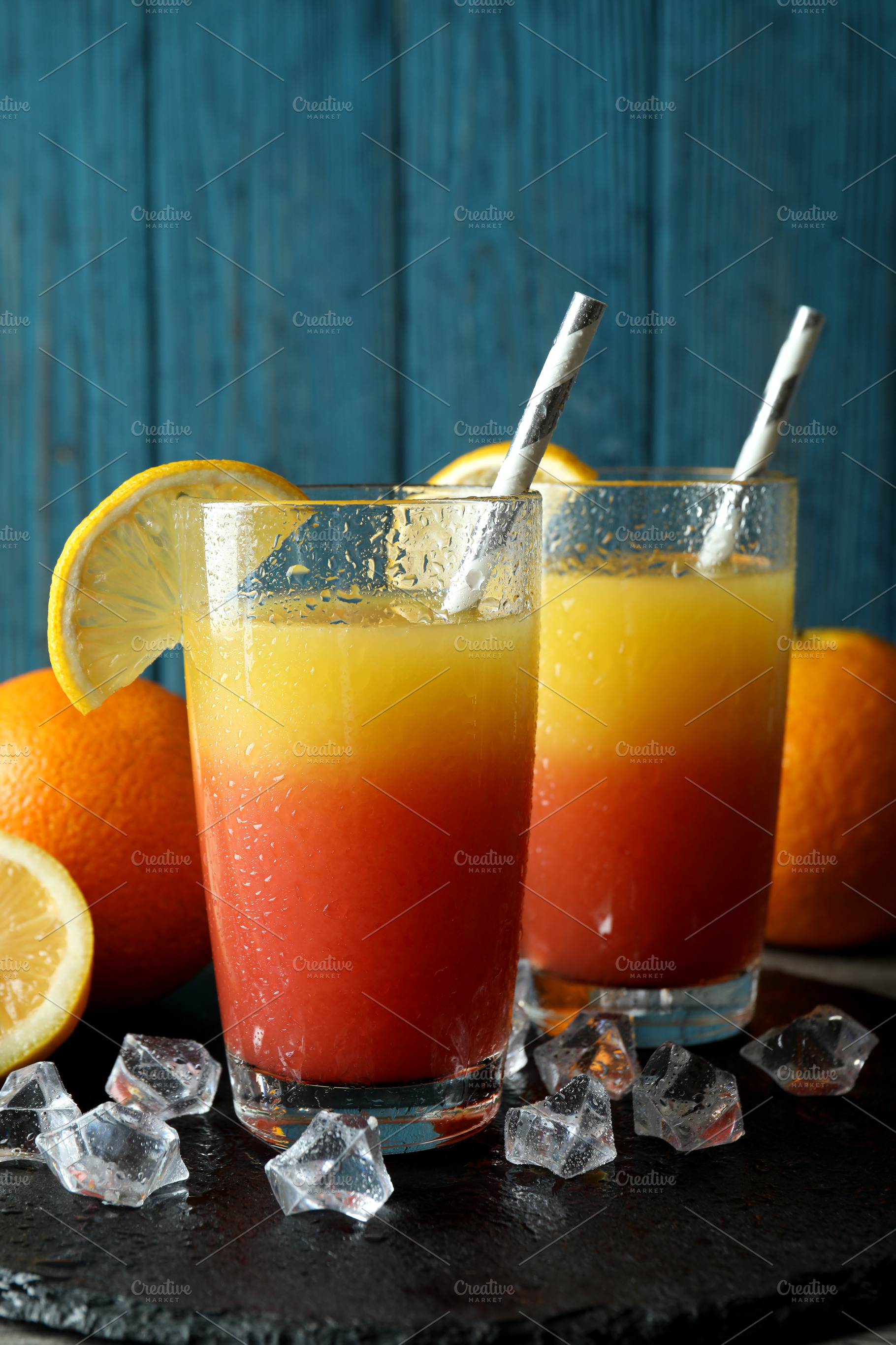Tequila Sunrise cocktails and ingredients against wooden backgro, a Food & Drink Photo by AtlasStudio PRO