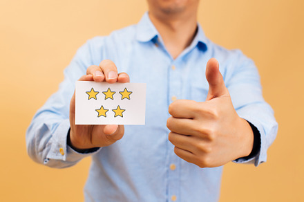 Businessman showing five yellow star containing customer, ranking, and service, a Person Photo by Twinster Photo