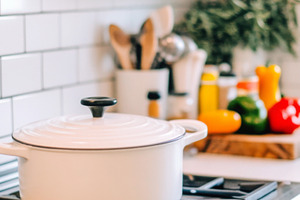 White pot on a stovetop in a modern, a Photo by Dvoevnore photos