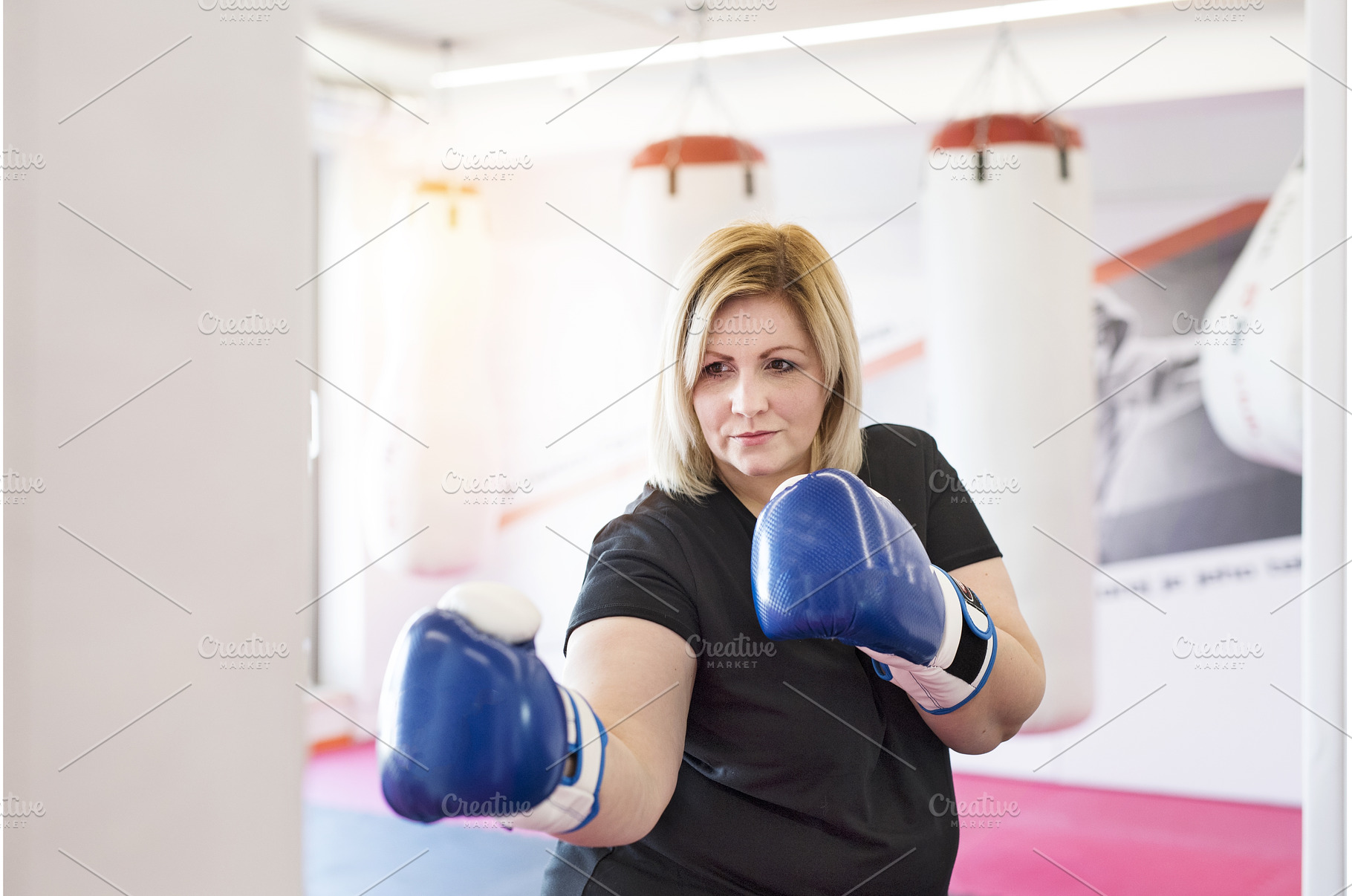 Overweight woman is working out in, a Sports & Recreation Photo by HalfPoint