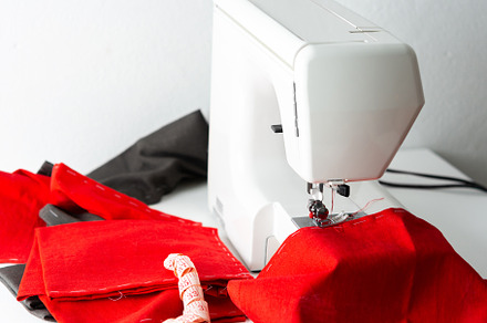 Sewing machine with red fabric, a Beauty & Fashion Photo by Pandateam