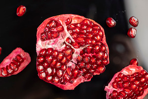 peeled ripe red pomegranate with juicy grains, top view of the object, a Photo by rsoollAI