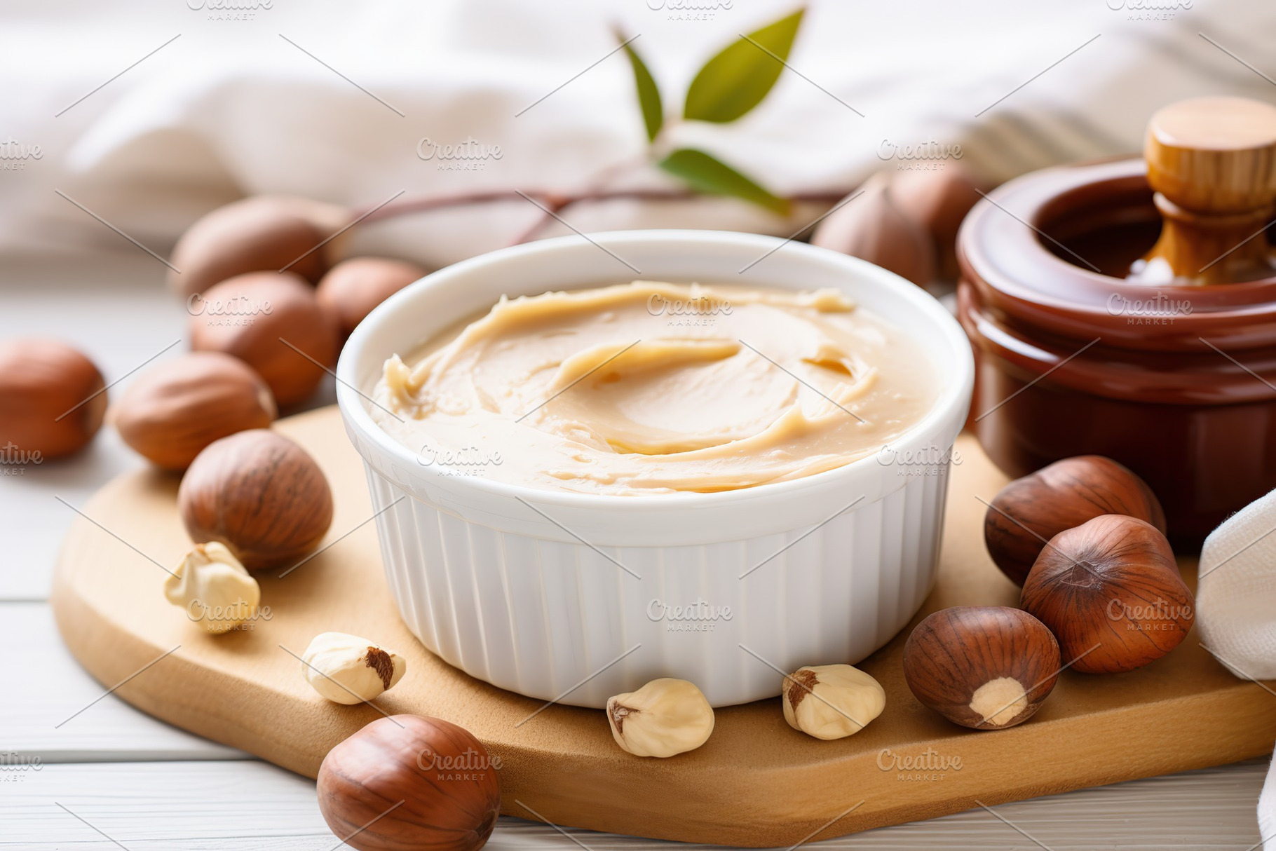 Bowl of hazelnut butter on wooden background, a Food & Drink Photo by AlyaAnd