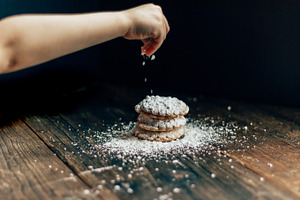 Sprinkling sugar on cookies