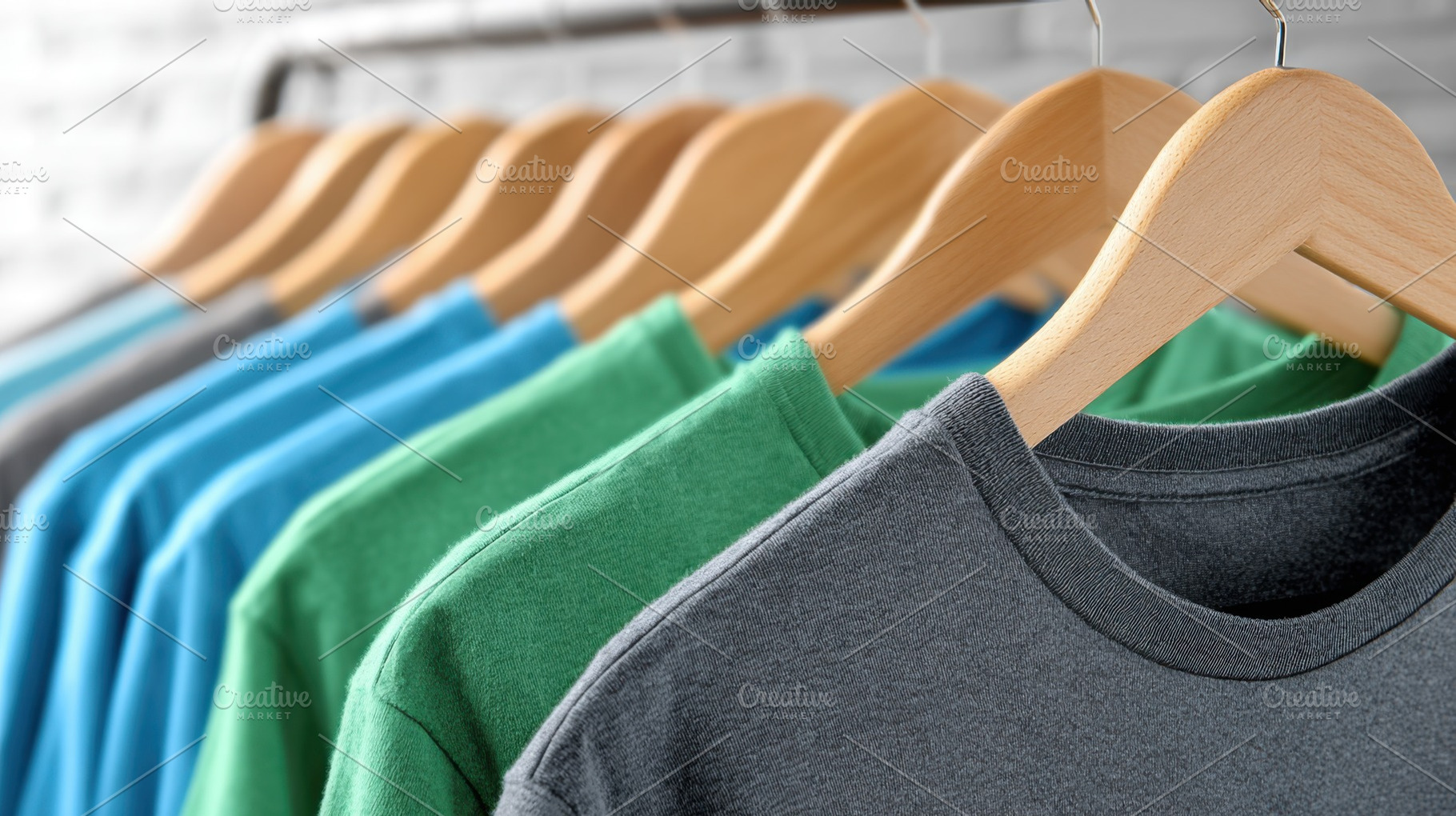 Colorful t-shirts hanging on rack, a Photo by Beautiful things