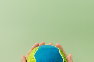 Earth in hands symbolizing sustainability, global environmental, a Photo by salmon.black