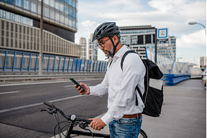 Manager on bike, reading text, a Person Photo by HalfPoint