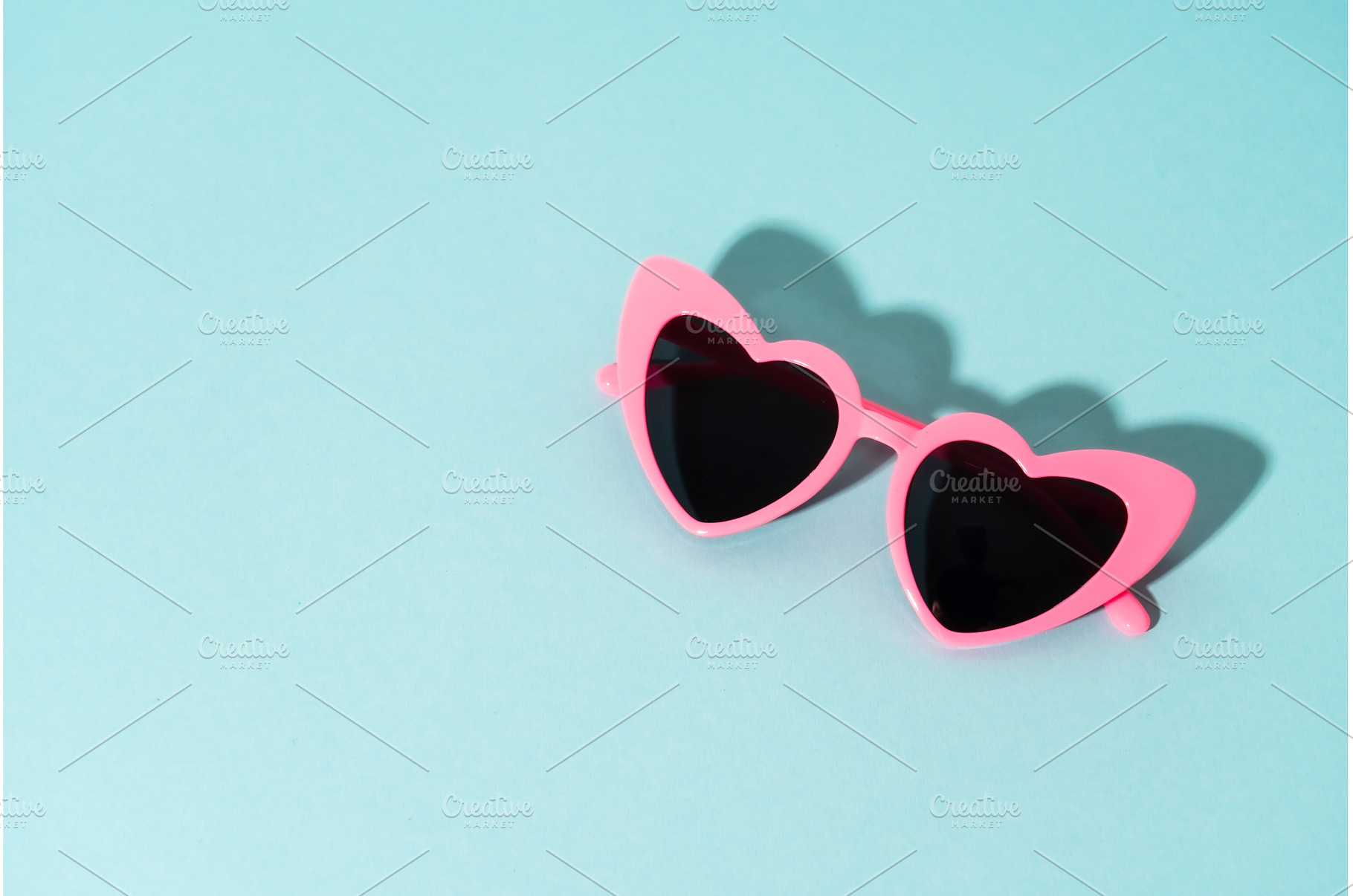Heart-shaped glasses on a colored, an Arts & Entertainment Photo by Nadia-nb
