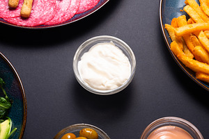 Mayonnaise in a small glass bowl on a black background. Creamy w, a Food & Drink Photo by MDBildes