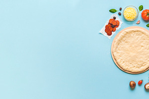 Pizza dough and ingredients top view