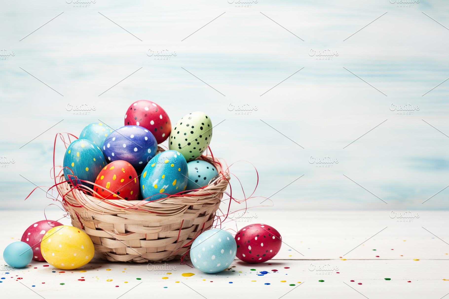 Basket with colorful easter eggs on wooden background, a Holiday Photo by AlyaAnd