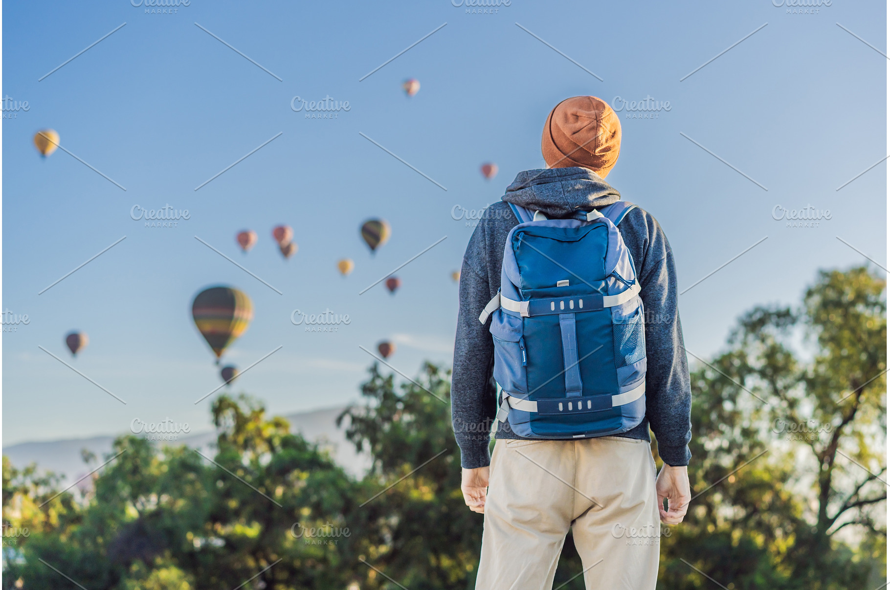 Male tourist standing with colorful, a Holiday Photo by Elizaveta Galitskaya