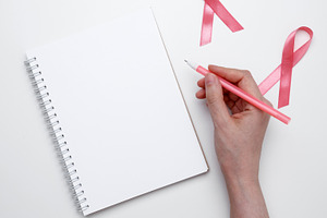 Symbolizing breast cancer awareness. Woman scheduling preventive checkup with v, a Photo by matucha