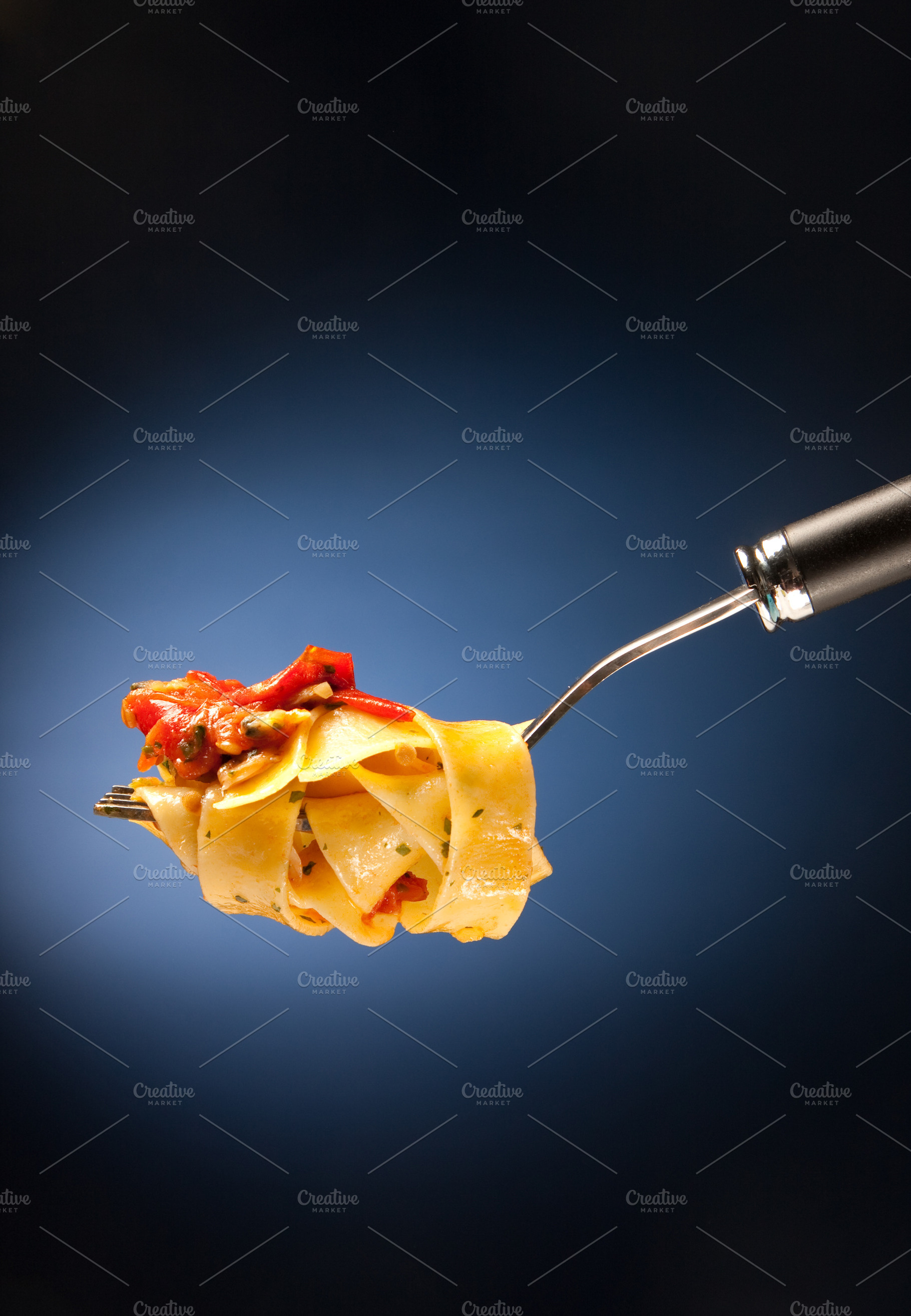 Tagliatelle with clams on a red background, a Food & Drink Photo by FoodStock