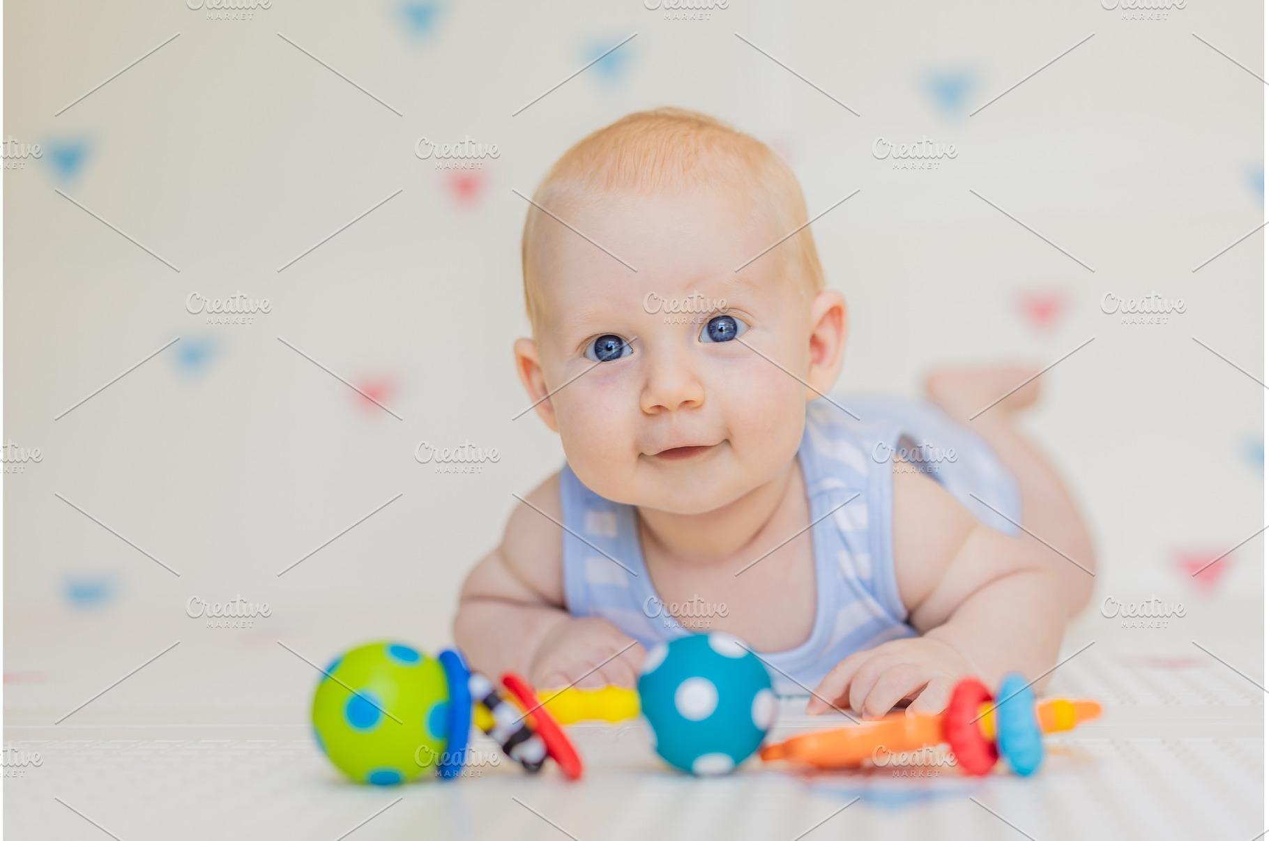 Adorable baby playing with colorful, a Person Photo by Elizaveta Galitskaya