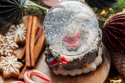 A snow globe and christmas candles with branches of fir., a Holiday Photo by Olena Rudo