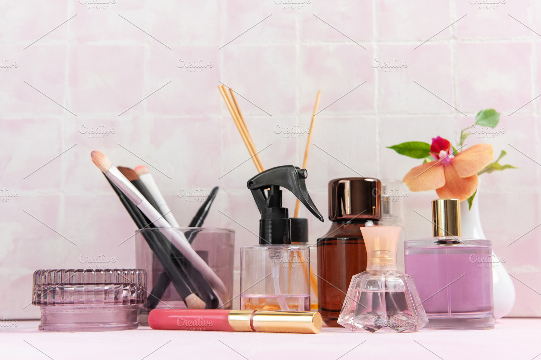 Beauty products and perfume bottles on pink background, a Beauty & Fashion Photo by Olena Rudo
