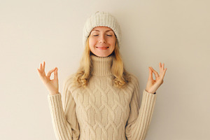 Relaxed happy young woman meditates