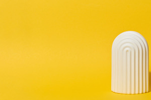 White decorative arch-shaped object with textured vertical lines, a Background Photo by ndanko