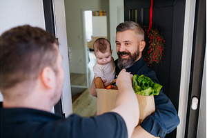 Father holding a baby in his arms, a Food & Drink Photo by HalfPoint