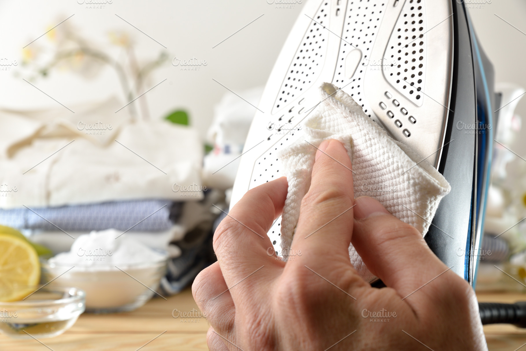 Detail of person cleaning steam iron with homemade natural produ, a Technology Photo by Davizro's Market