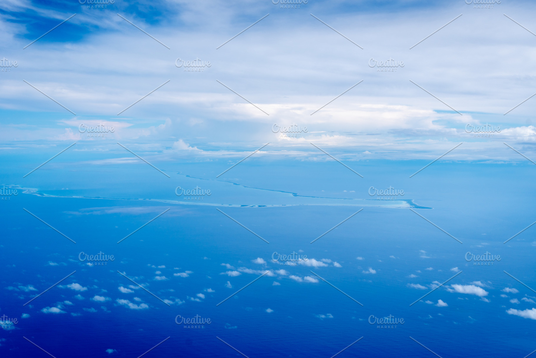 Aerial view of the Tuamotus atoll in French Polynesia with cloud, a Nature Photo by GoodGoods
