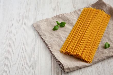 Raw Organic Spaghetti Pasta in a Bunch, side view. Copy space., a Food & Drink Photo by LiudmylaChuhunova