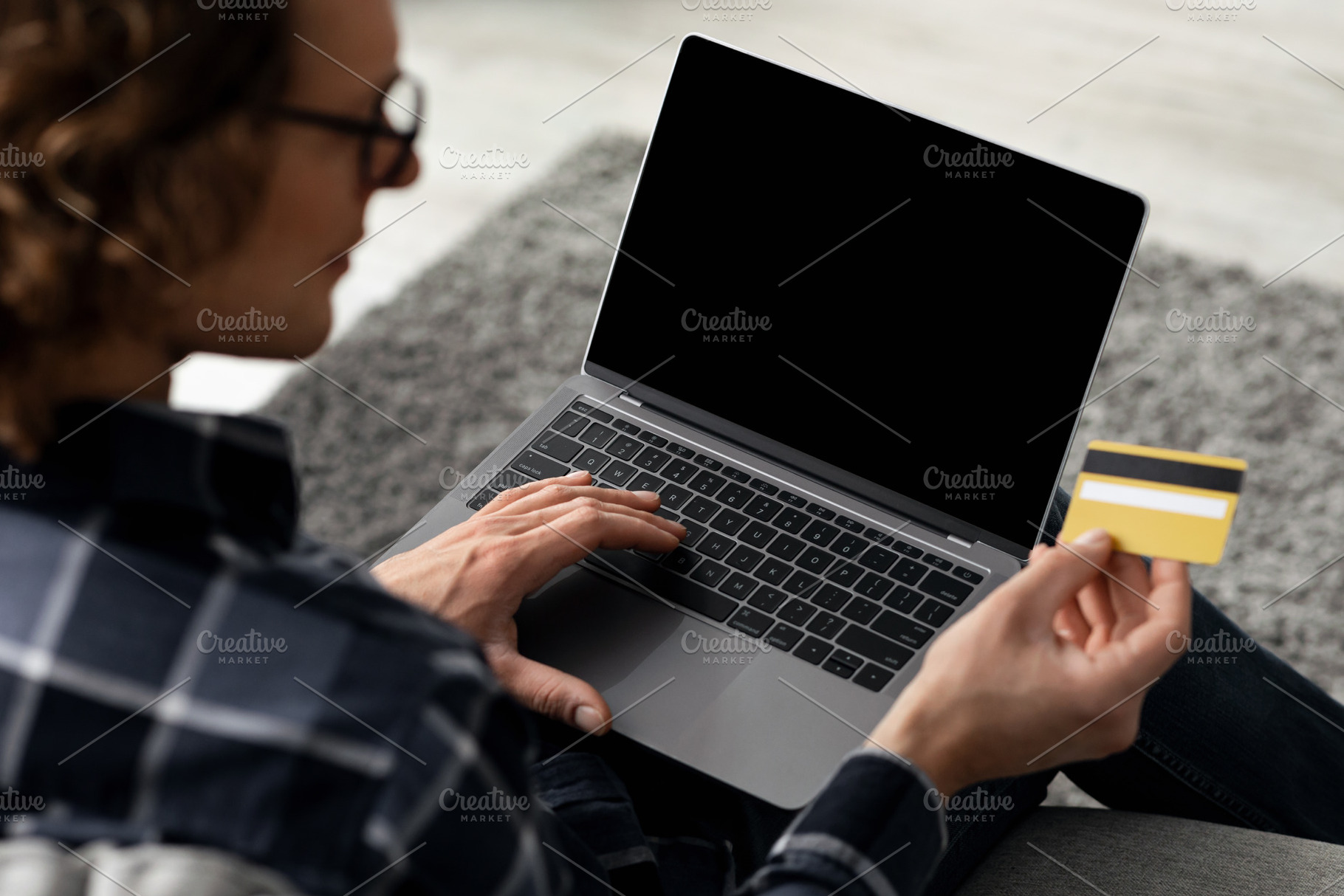 Man Using Laptop And Credit Card Shopping Online Indoor, Back-View, a Background Photo by Prostock-Studio