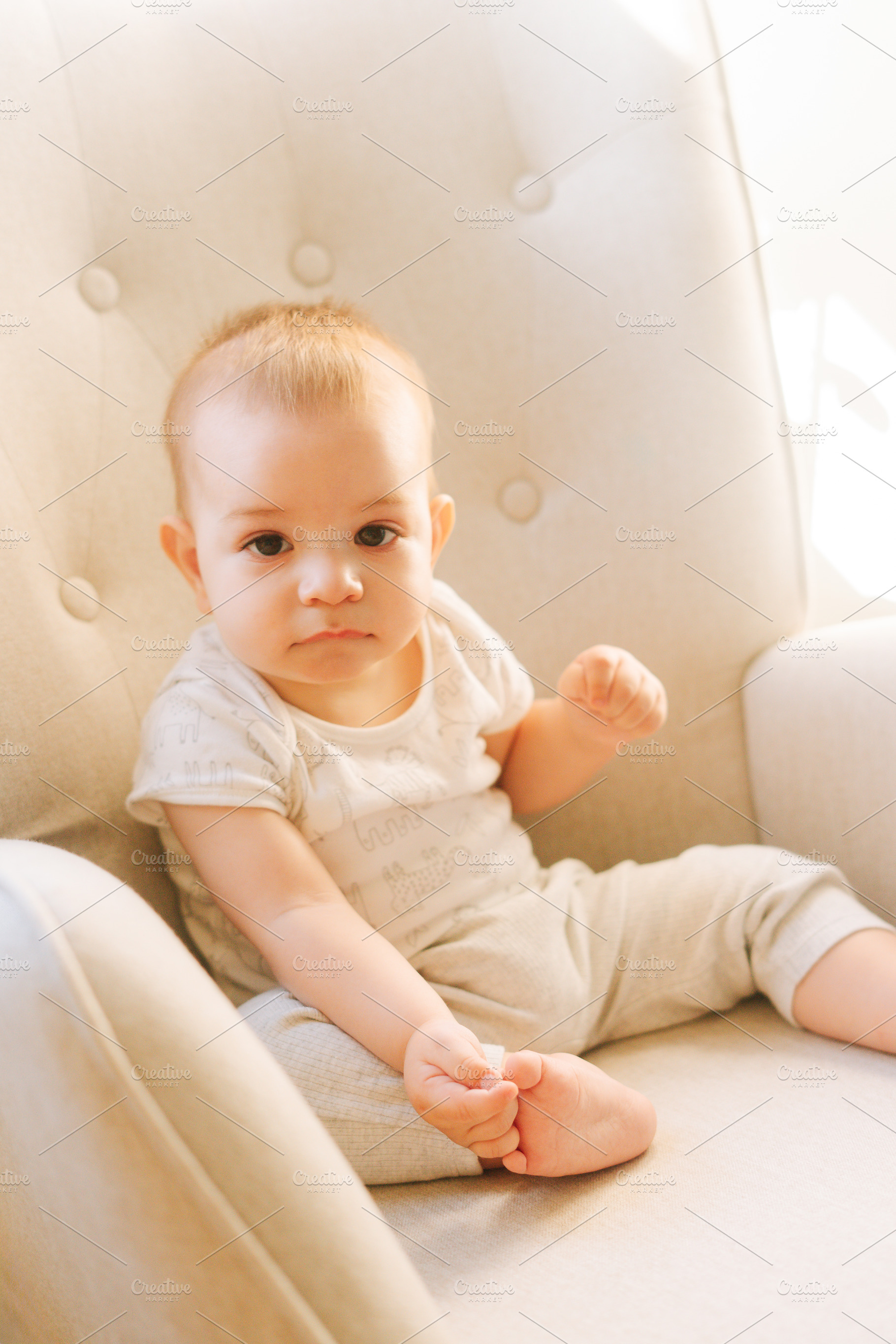 Portrait of a nine month old baby sitting in a rocking chair, a Person Photo by rubenchase