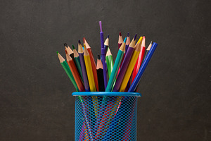 Multi-colored pencils in a blue metal cup, sharpener and erasers, a School & Education Photo by ndanko